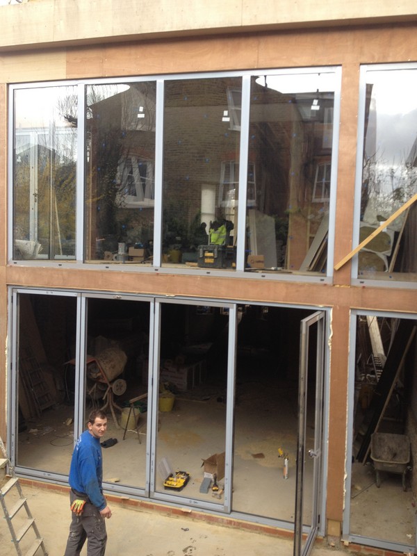 Aluminium bi-fold doors with two-storey glazing in Ealing