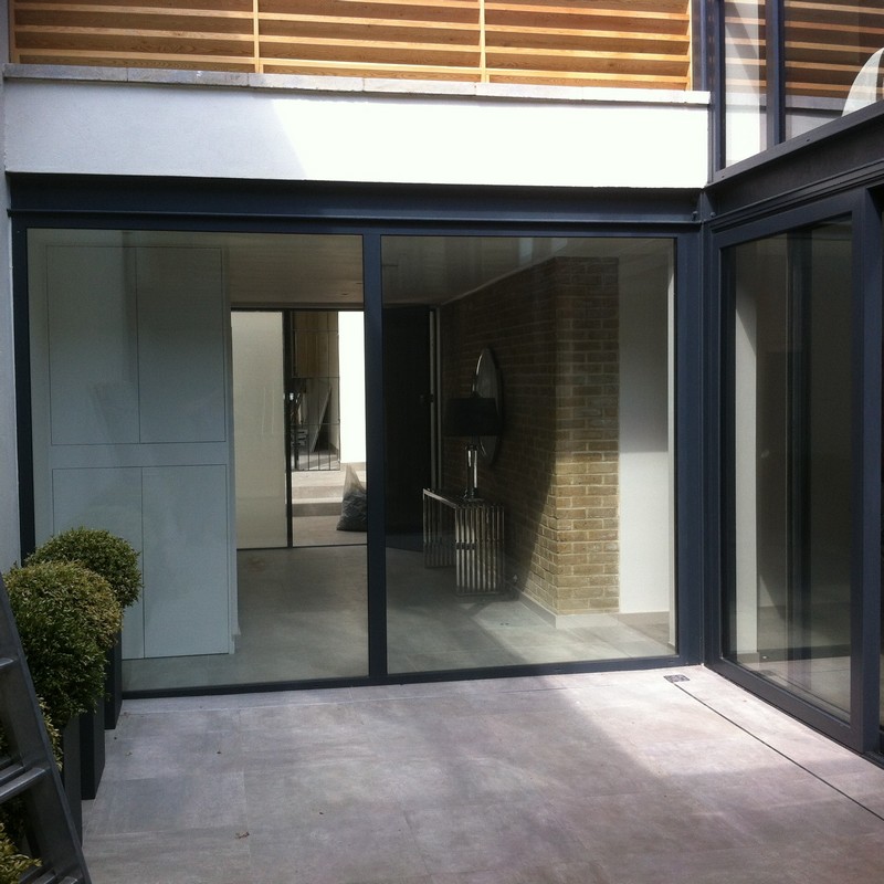 Floor-to-ceiling sliding doors opening to courtyard in Ealing