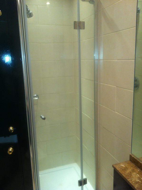 Frameless glass shower enclosure with chrome fittings in Ealing