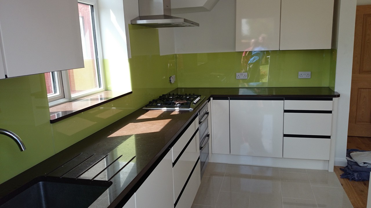 Lime green glass kitchen splashback installed by Ealing glaziers