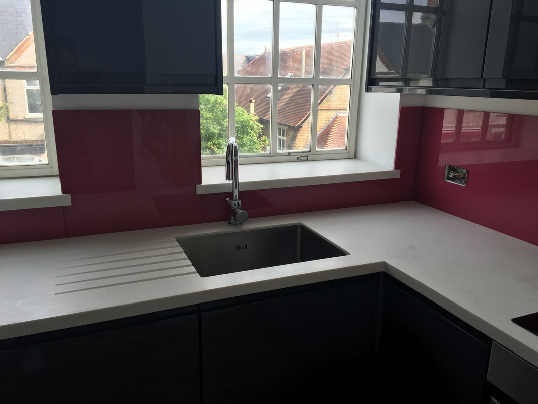 Deep plum coloured glass splashback in modern Ealing kitchen